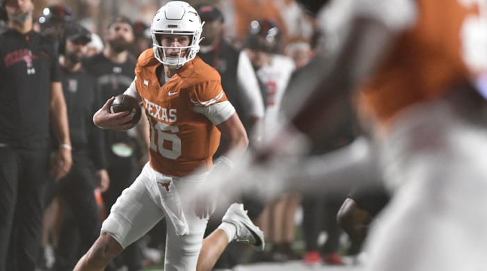 Texas quarterback Arch Manning runs with the ball in a game against Texas Tech on Nov. 24, 2023.